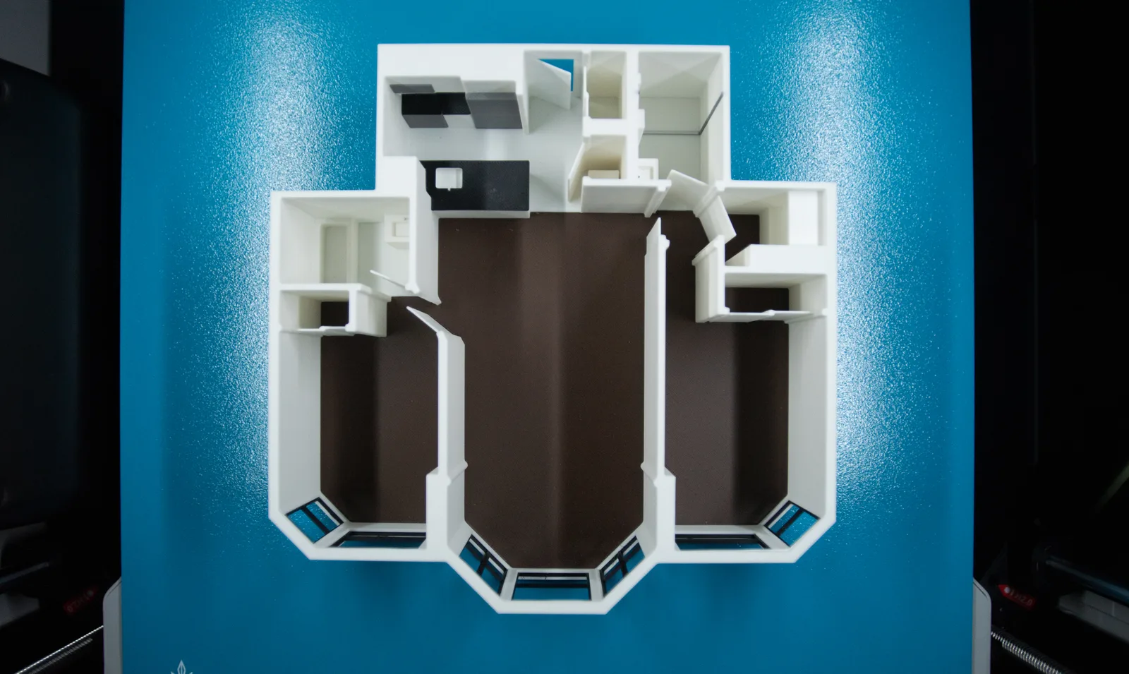 Top-down view of a 3D printed floor plan model with bay windows